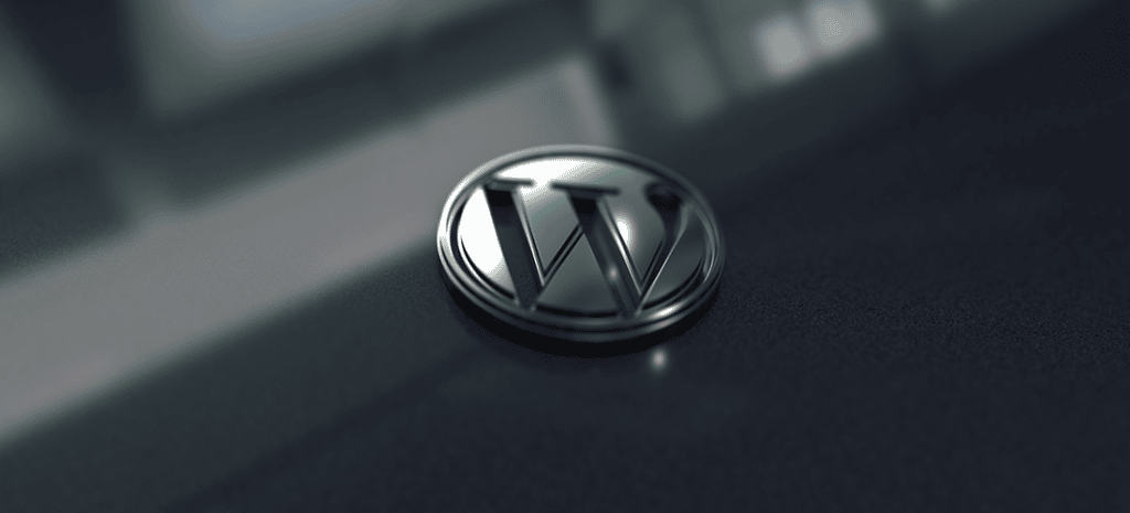 a metallic version of the WordPress logo on a glassy surface