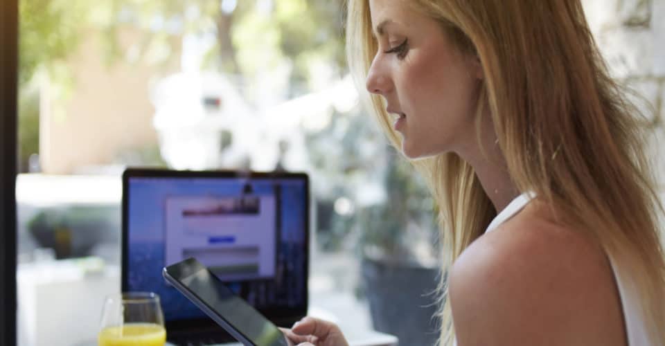 woman sitting at desk waiting on website to load