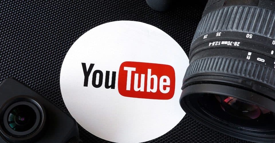 YouTube logo next to camera and photographic objective