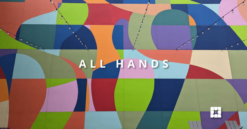 a colorful wall mural. Overlaid on the image are the words All Hands and the WP Engine logo