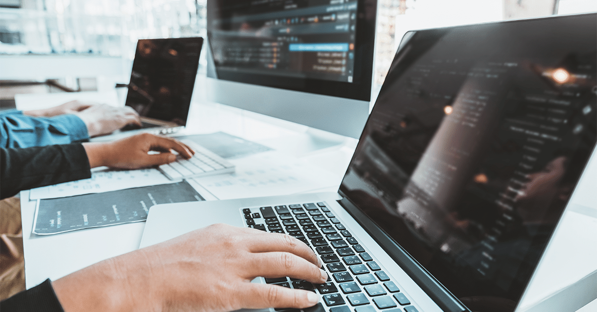 Person working on a laptop at a desk