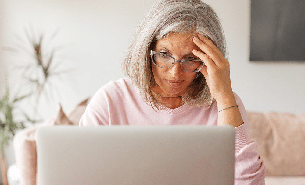 an older woman gets frustrated while navigating a website