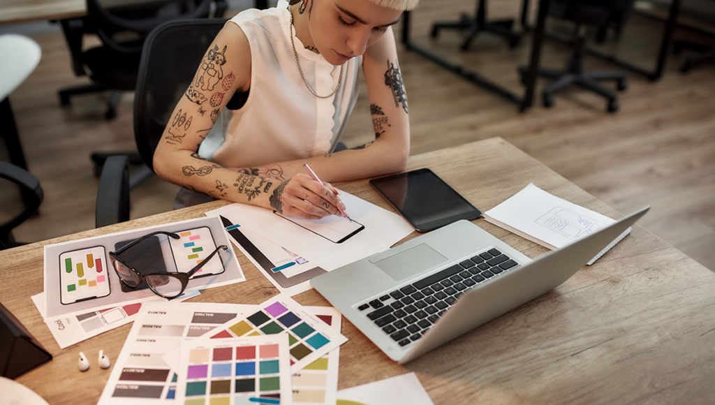 11 web design trends to watch in 2024. A web designer plans the look of a new website at a desk