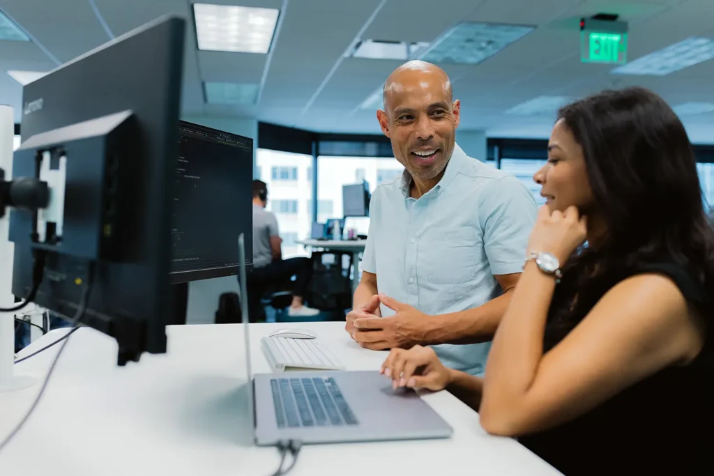 two people at an agency discussing recurring revenue