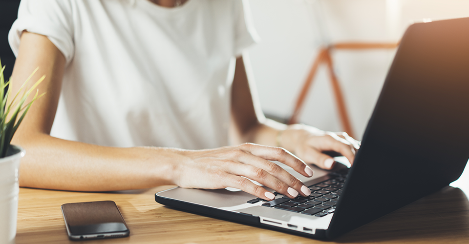 a woman opens the WordPress dashboard on a laptop