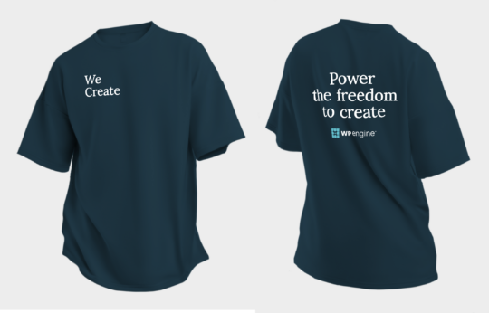 Front and back of the navy blue t-shirts WP Engine will give away at our booth at WCEU. Front right breast of the shirt reads "We Create." The back of the shirt reads "Power the freedom to create" above the WP Engine logo