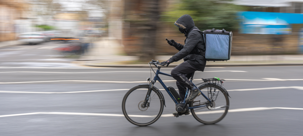 local bike delivery person checking location on mobile