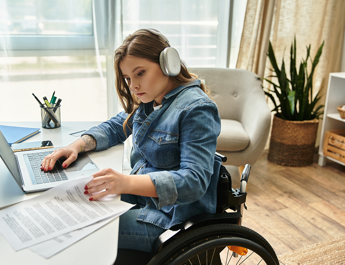 Mixd - Family Fund case study: girl in a wheelchair works at a desk.