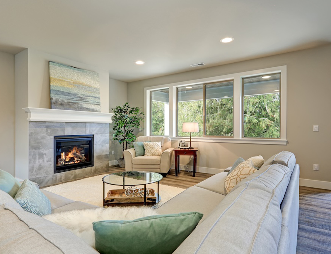 Wpromote - The New Home Company case study: a new home living room with fireplace alight.